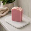 White soap saver mat with pink handmade soap in a bathroom setting